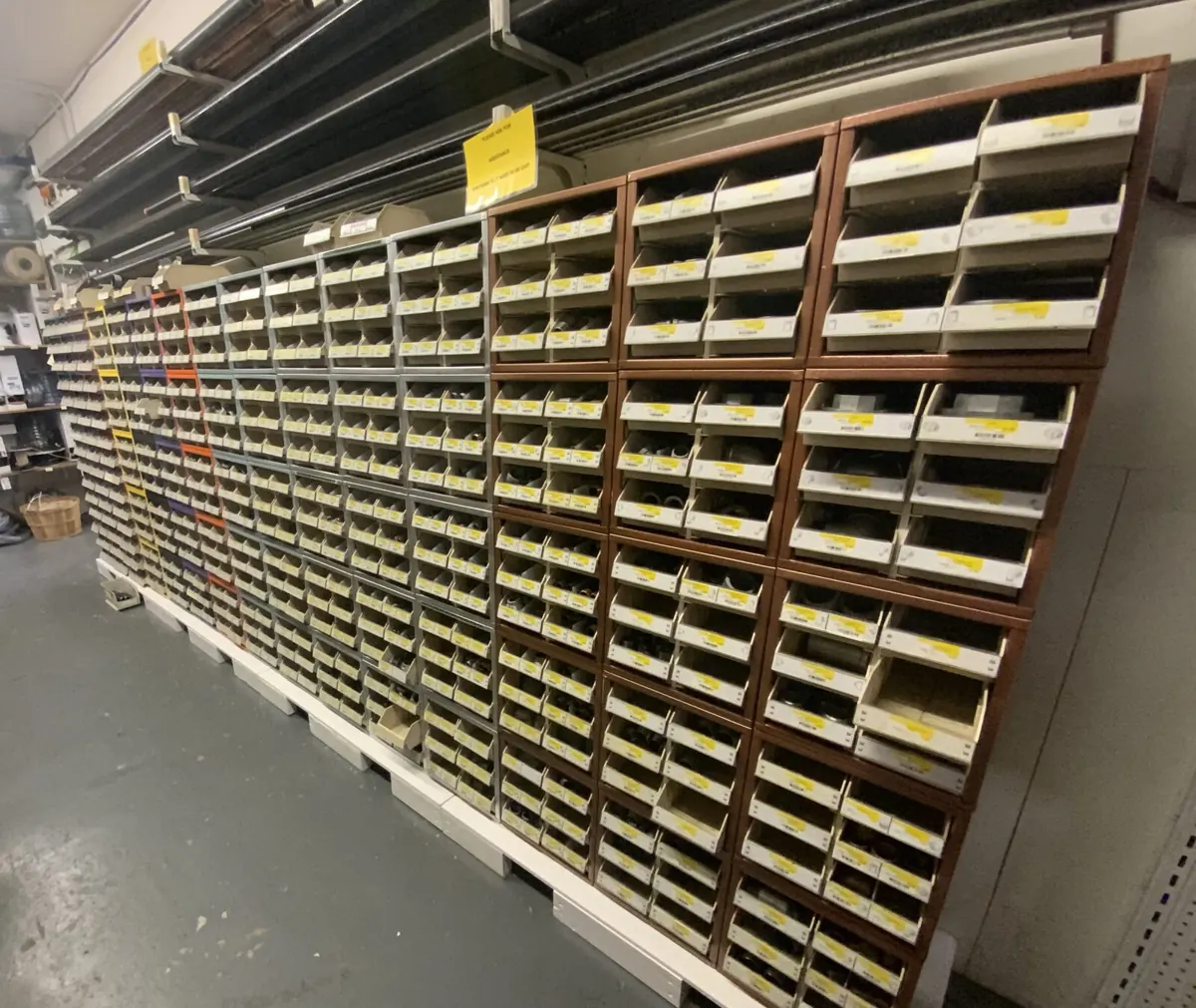 A long aisle of fastener bin drawers