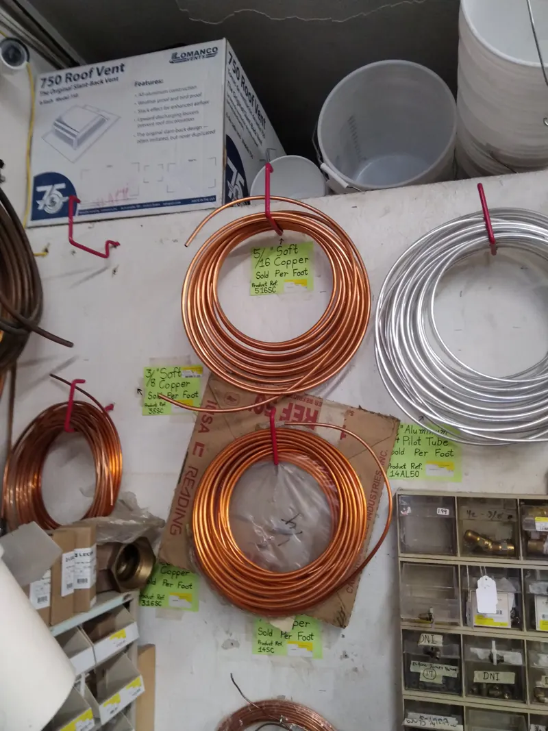 Coils of copper tubing hanging on the wall