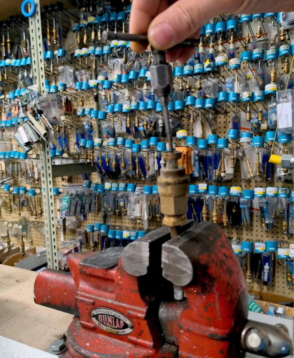 A faucet stem held in the vise for matching