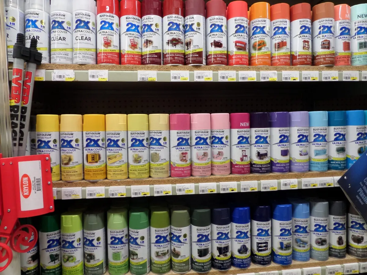 A wall of spray paint in every color